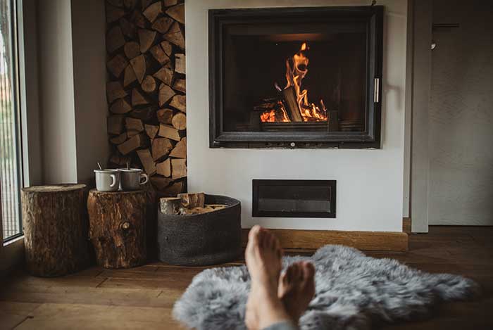 Woman feet near a fireplace